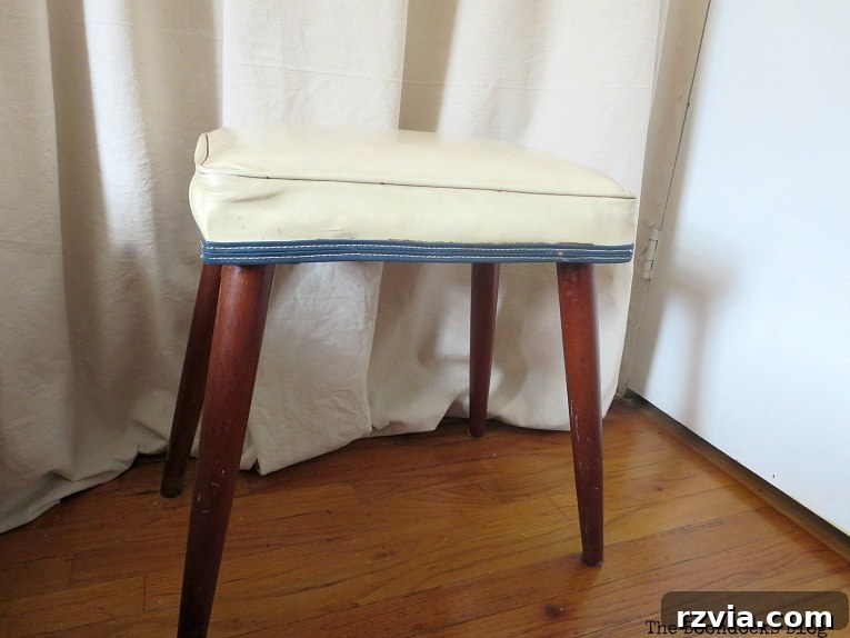 Original small vinyl bench before its Mid-Century Modern makeover, showing wear and tear.