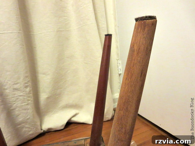 Mid-Century Modern bench leg partially sanded, showing stark contrast between old stain and lighter wood underneath.