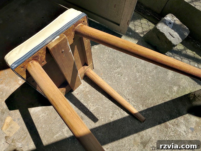 Frustrated attempt to sand the remaining legs of the Mid-Century Modern bench with a failing hand sander.