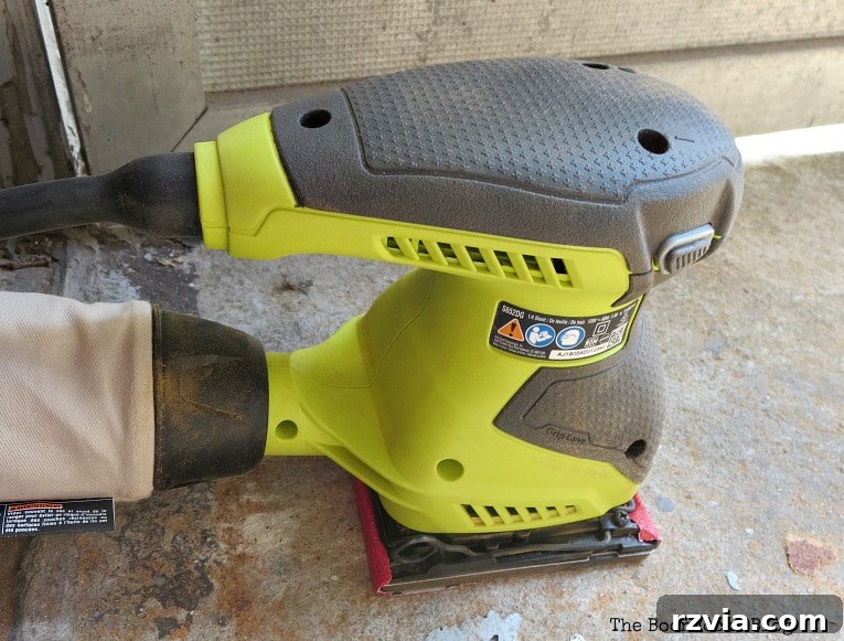 Newly acquired Ryobi orbital sander, proving essential for the stubborn Mid-Century Modern stool makeover.