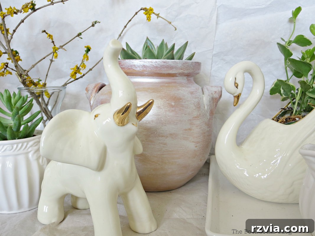 Beyond the Bin: DIY Upcycled Planters 3 Ceramic elephant amidst a collection of household items reimagined as planters, featuring succulents and small plants.