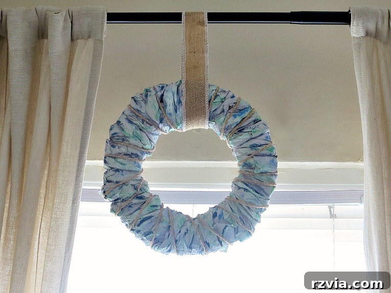 Bright Ideas Easy Colorful Packing Paper Wreath 12 A vibrant, colorful packing paper wreath elegantly hung on a curtain rod, showcasing its new place within the living room decor and adding a cheerful touch.
