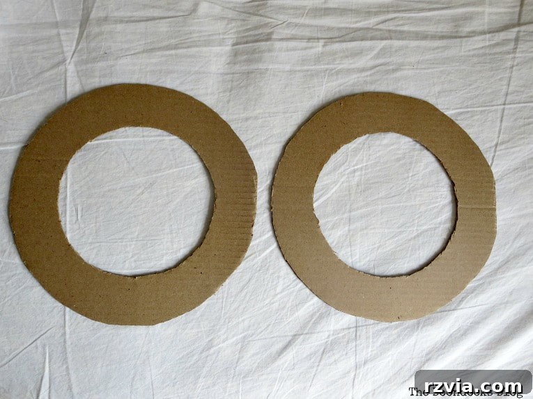 Bright Ideas Easy Colorful Packing Paper Wreath 3 Two donut-shaped cardboard pieces cut out to form the base of the DIY paper wreath, showcasing a frugal and customizable approach to crafting.
