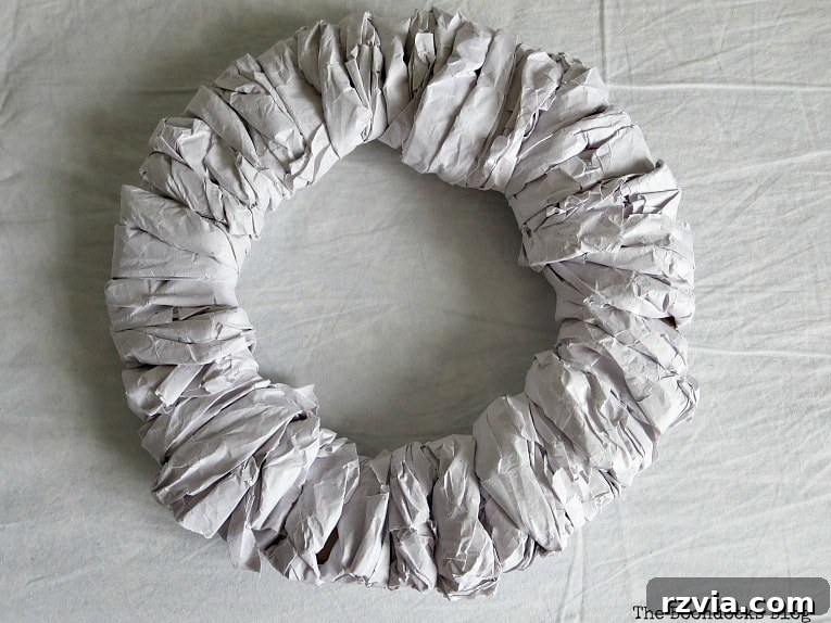 Bright Ideas Easy Colorful Packing Paper Wreath 7 A fully wrapped cardboard wreath form, showcasing the beautiful texture and fullness achieved by expertly twisting and wrapping packing paper without the need for glue.