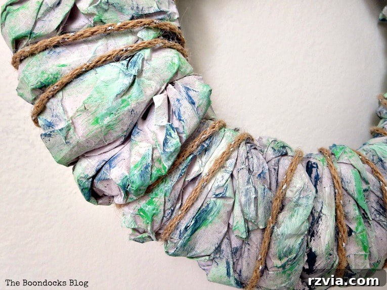 Bright Ideas Easy Colorful Packing Paper Wreath 10 Twine thoughtfully wrapped around the painted packing paper wreath, adding a rustic and textural element to the easy DIY craft project.