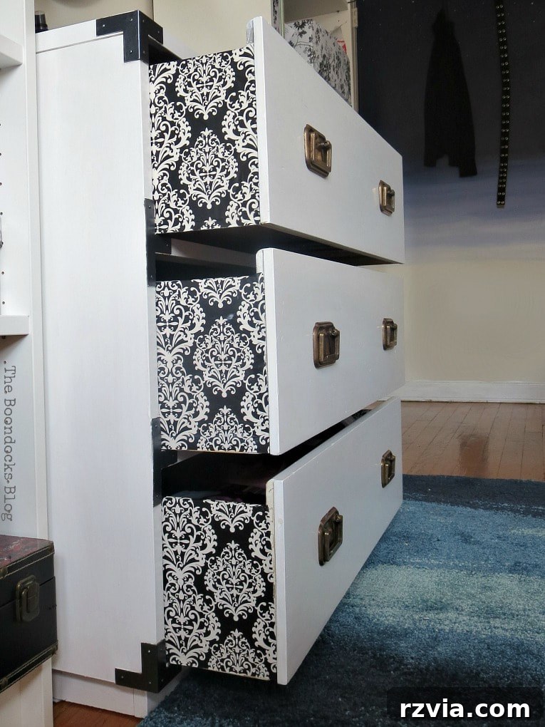 Bringing a Campaign Dresser Back to Life 12 Side view of the upcycled dresser, featuring the distinctive Damask paper applied to the sides of its drawers, adding a unique touch.