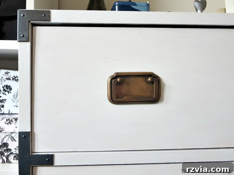 Bringing a Campaign Dresser Back to Life 8 Detailed view of both the brass handles and the newly painted metallic black hardware on the dresser's sides.