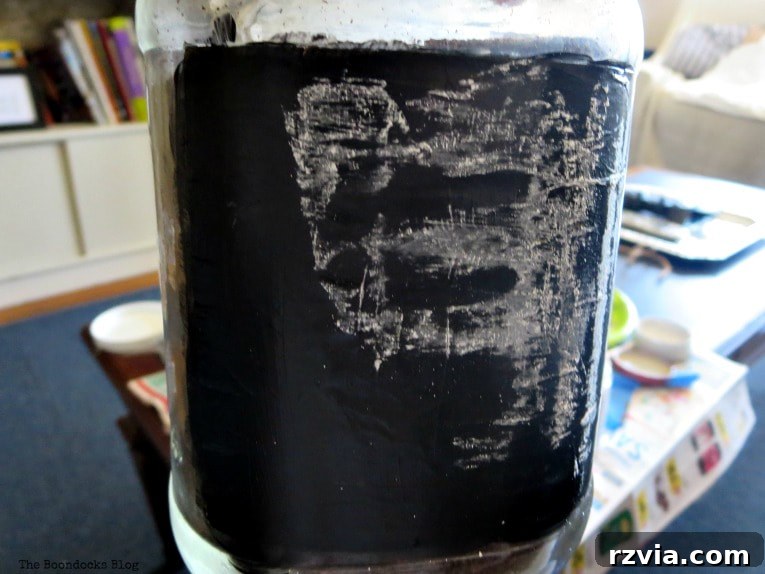 Crafting Your Charmingly Casual Coffee Nook 15 A glass jar with a partially completed chalkboard label, showing the process of applying chalkboard paint.