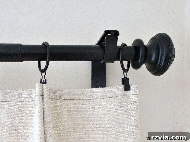 Crafting Elegant Pleated Curtains from Humble Drop Cloths 11 A drop cloth curtain fabric folded into a 'V' shape, with a clip ring attached, for a side pleat.