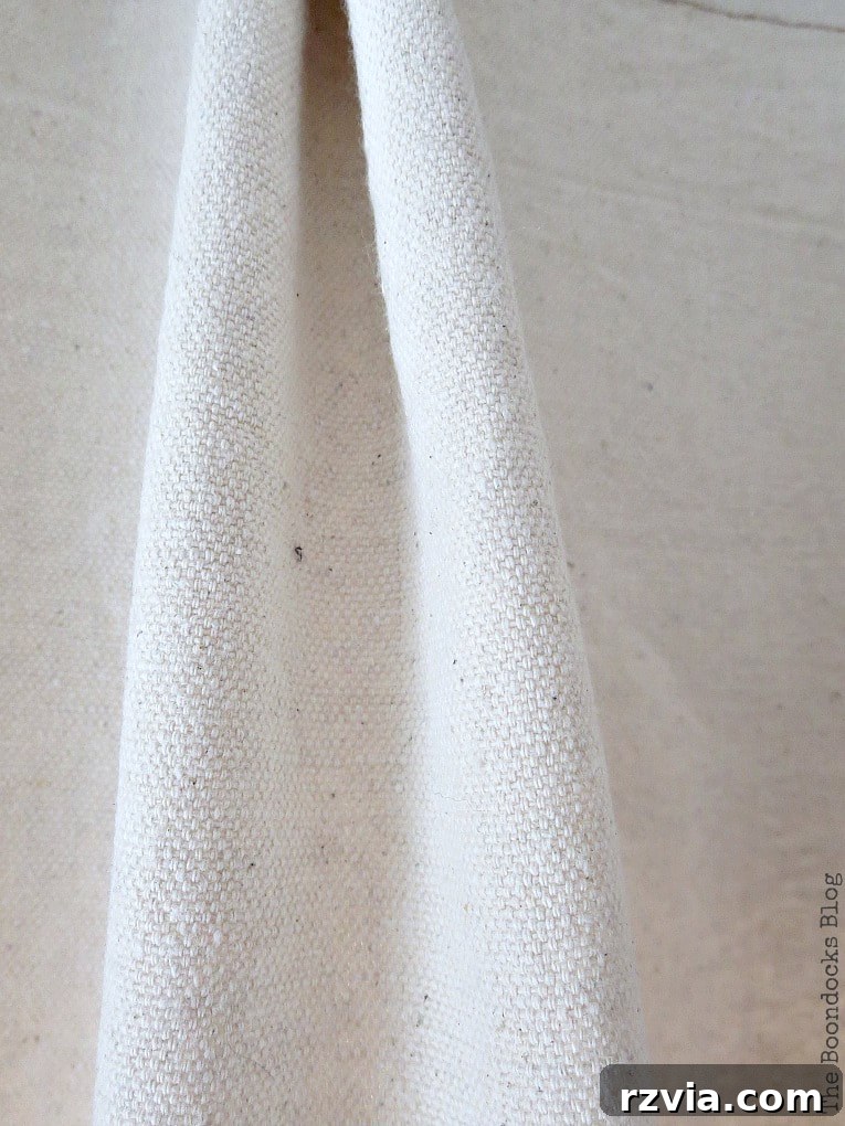 Crafting Elegant Pleated Curtains from Humble Drop Cloths 15 Detailed close-up of the densely woven canvas drop cloth fabric, highlighting its texture and quality.