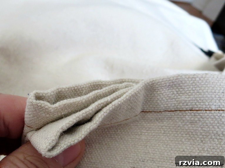Crafting Elegant Pleated Curtains from Humble Drop Cloths 9 Close-up of a drop cloth curtain fabric folded into a 'W' shape, ready for a clip ring.