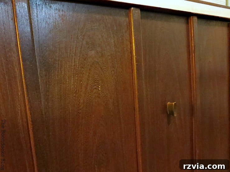 Revitalize Your MCM China Cabinet 13 A detailed close-up of the unpainted front of the cabinet's bottom section, highlighting its preserved, exquisite walnut grain patterns.