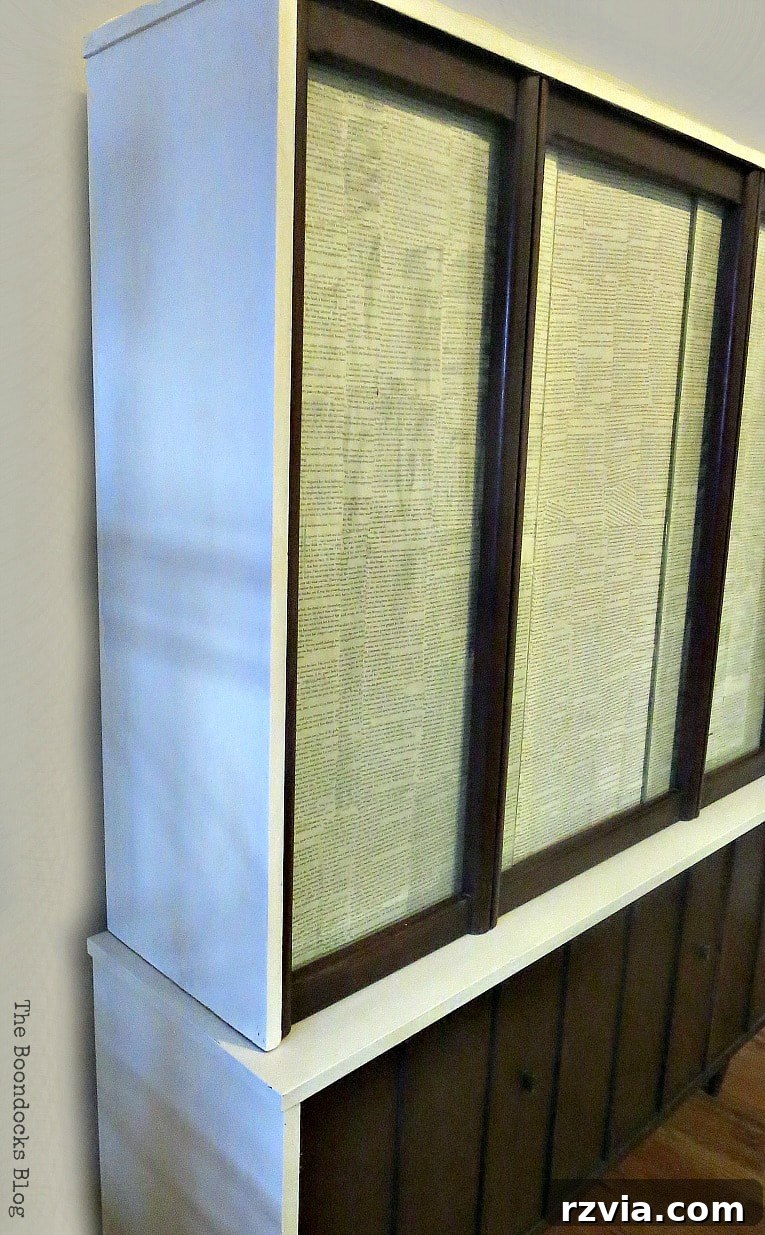 Revitalize Your MCM China Cabinet 23 Side view of the elegantly updated china cabinet, showcasing its cohesive design and smooth finishes.
