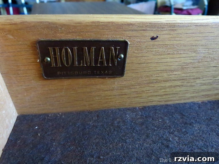 Revitalize Your MCM China Cabinet 6 Close-up of the original metal manufacturer's label for Holman Furniture, providing a glimpse into the cabinet's origin.