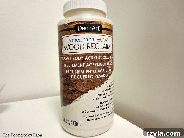 Revitalize Your MCM China Cabinet 10 Close-up of wood reclaim being applied to the area where veneer had peeled off, demonstrating the restoration technique.