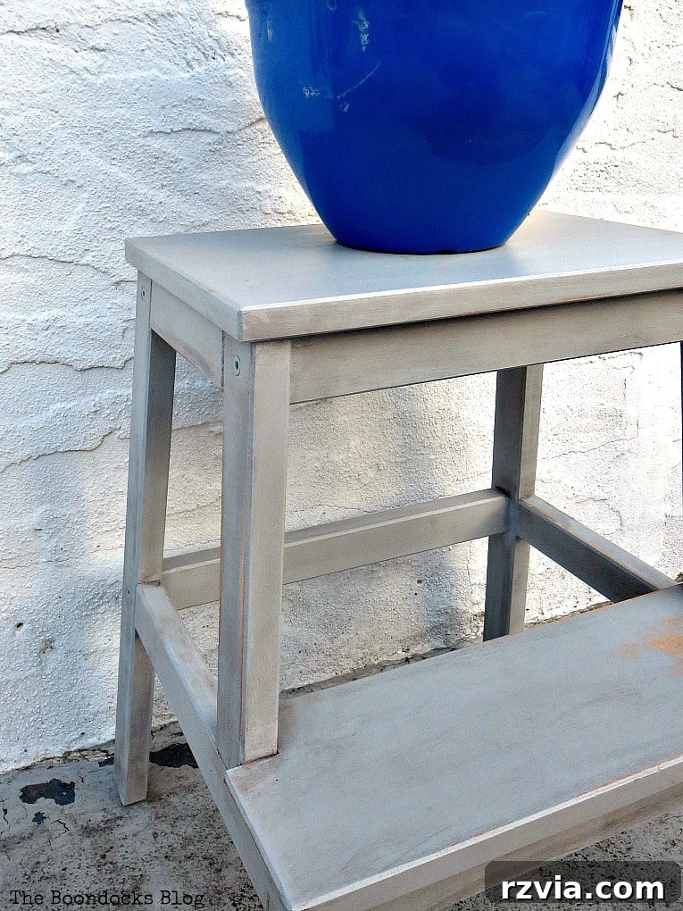 Your Ikea Bekvam Step Stool Reinvented 17 The painted Ikea stool, now in a charming grey, serving as a stylish stand for a blue planter.