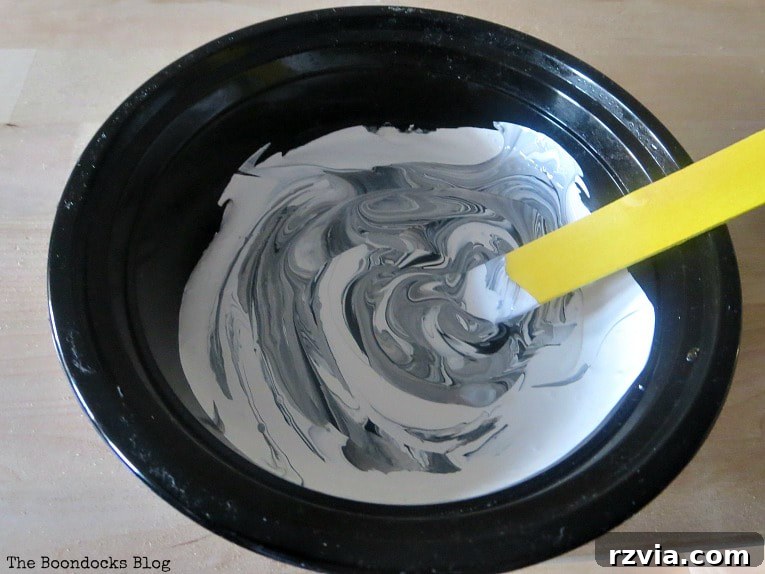 Your Ikea Bekvam Step Stool Reinvented 5 Mixing white chalky paint with black acrylic paint to create a custom gray base color for the stool.