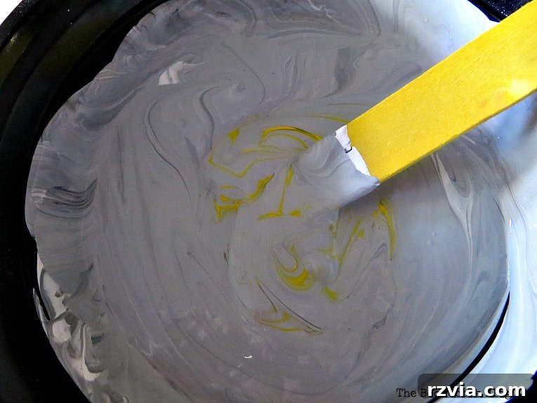 Your Ikea Bekvam Step Stool Reinvented 6 Adding yellow paint to the gray mixture to achieve a desired warm tone for the Bekvam step stool.