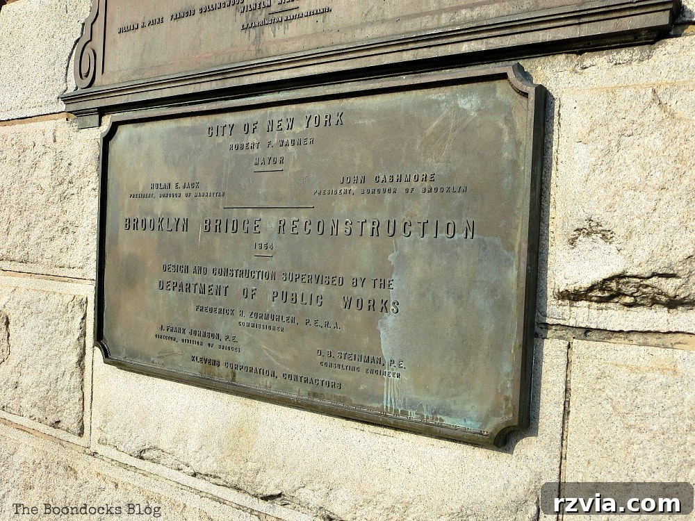 A historic plaque on the Brooklyn Bridge, detailing its construction and significance as a National Historic Landmark. A Tour of the Astonishing Brooklyn Bridge Walkway.