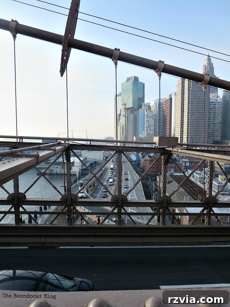 Looking south from the Brooklyn Bridge towards the imposing skyscrapers of the Financial District, with the FDR Drive below. A Tour of the Astonishing Brooklyn Bridge Walkway.