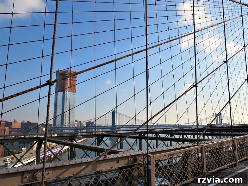 A striking view of the Manhattan Bridge from the Brooklyn Bridge, a sister suspension bridge connecting Manhattan and Brooklyn. A Tour of the Astonishing Brooklyn Bridge Walkway.