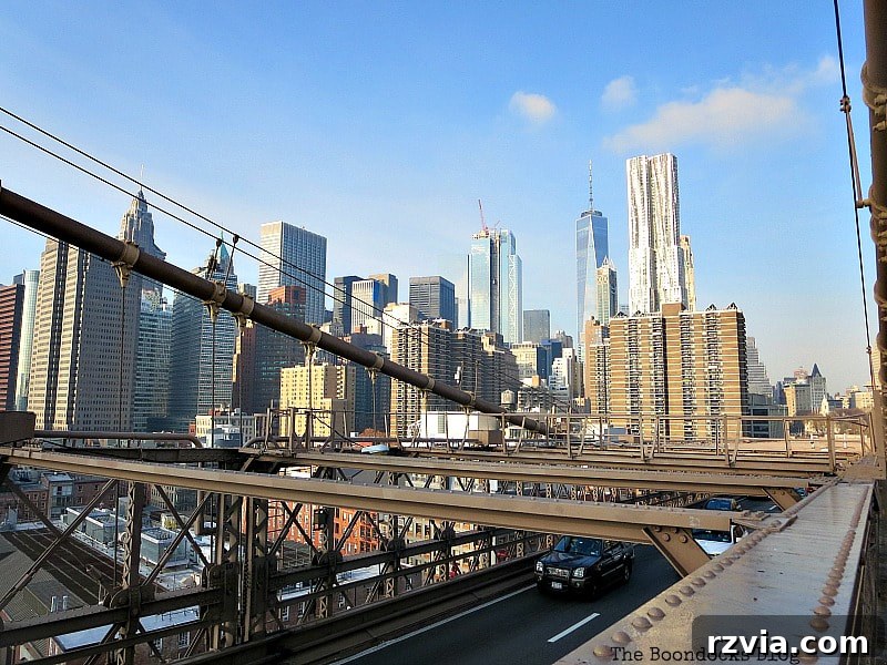 The iconic Financial District skyline with One World Trade Center prominent in the background, viewed from the Brooklyn Bridge. A Tour of the Astonishing Brooklyn Bridge Walkway.