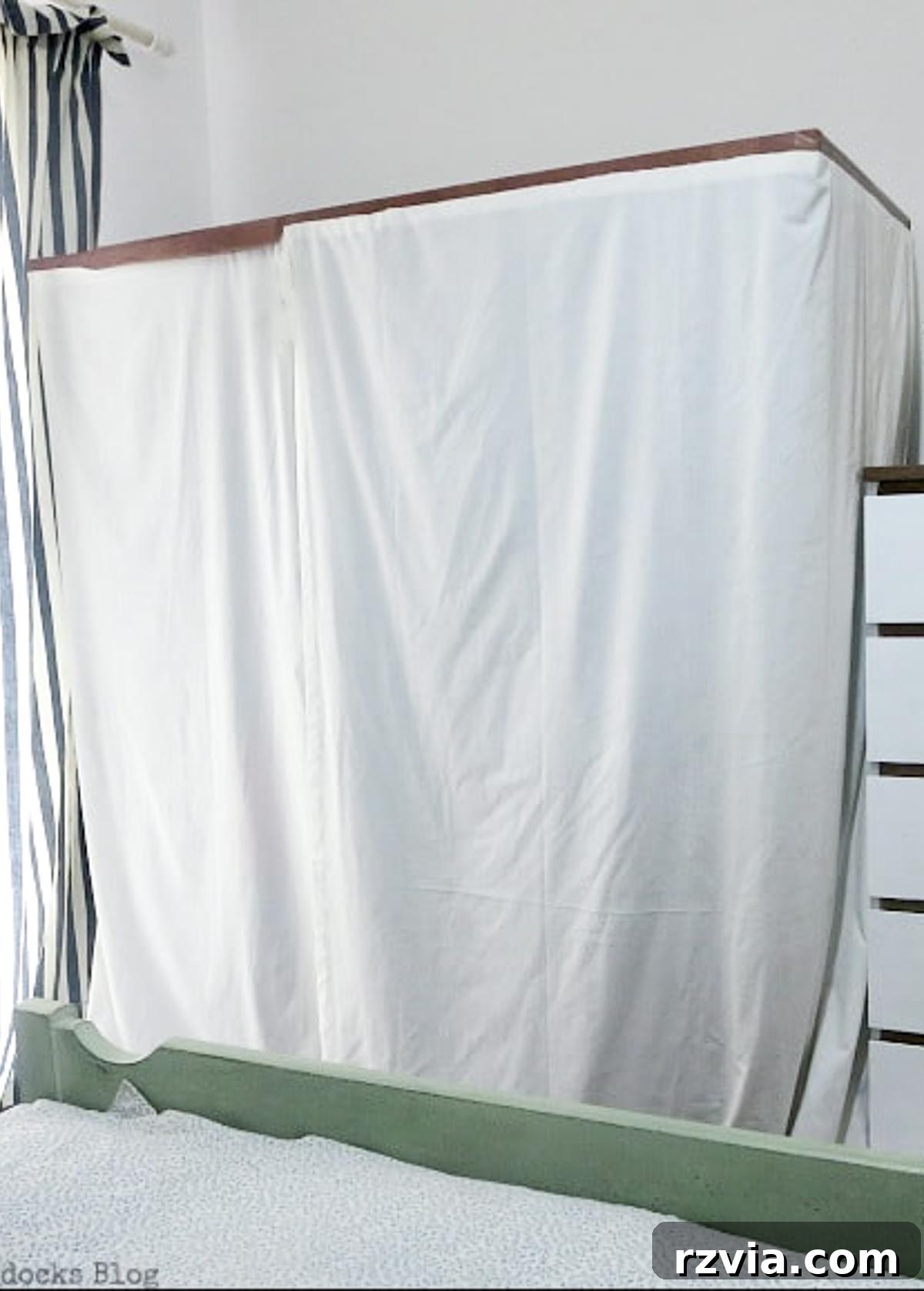 A custom-made clothes rack cover standing beside a dresser, creating a cohesive and organized bedroom aesthetic.