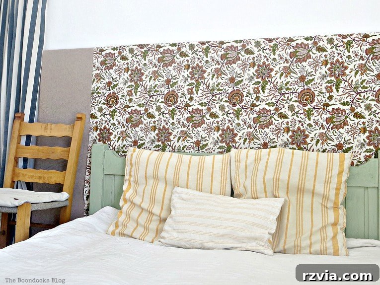 A detailed close-up of a floral fabric headboard, showcasing the intricate pattern and soft texture that adds warmth and character to the bedroom.
