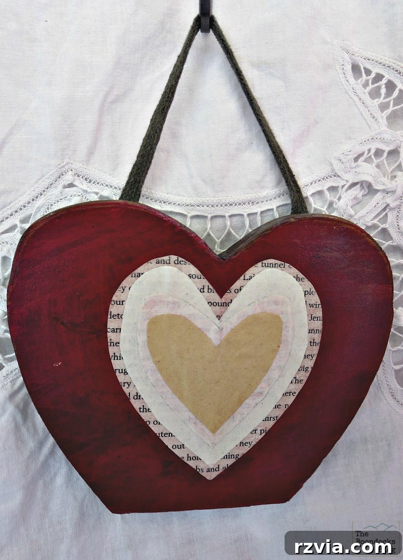 Sentimental DIY gift: a decoupaged heart crafted from repurposed scrap wood, perfect as a unique Valentine's Day token.