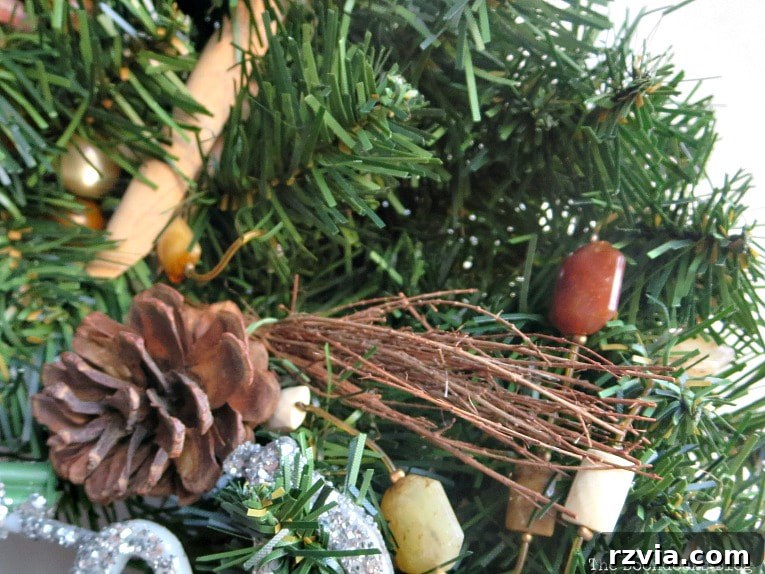 Kolay Rustik Noel Çelengi Yapımı ve 12 Ek Çelenk Fikri 4 Partially completed rustic Christmas wreath with pine cones already attached, ready for additional embellishments.