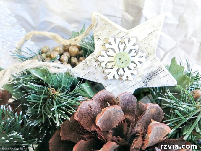 A close-up of a finished rustic birch star ornament, showing the twine loop for hanging and the detailed embellishment.