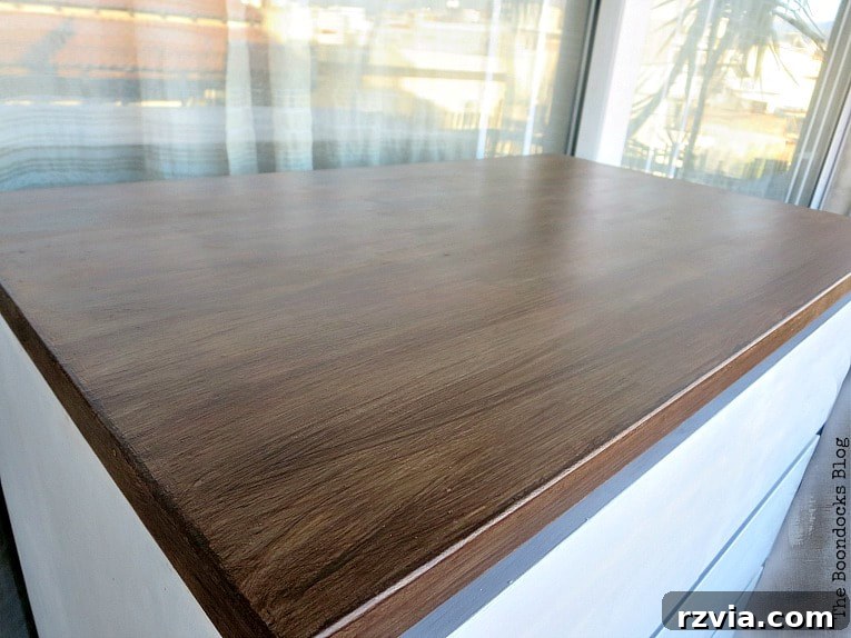 Stunning Black Ikea Malm Dresser Makeovers 15 The completed top of the dresser, now finished in a beautiful walnut brown with long, visible brush strokes.
