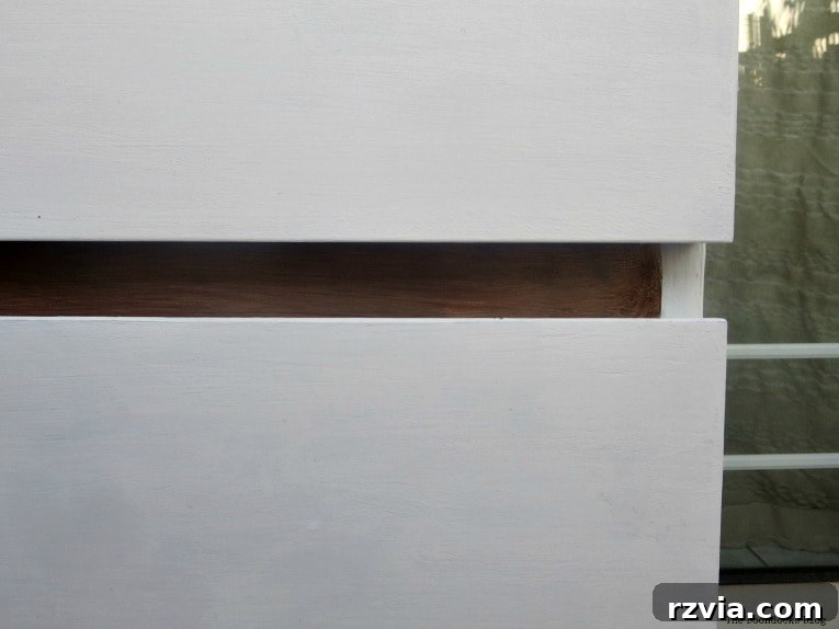 Stunning Black Ikea Malm Dresser Makeovers 18 A close-up view of the white drawers contrasting with the walnut-colored front frame of the dresser.
