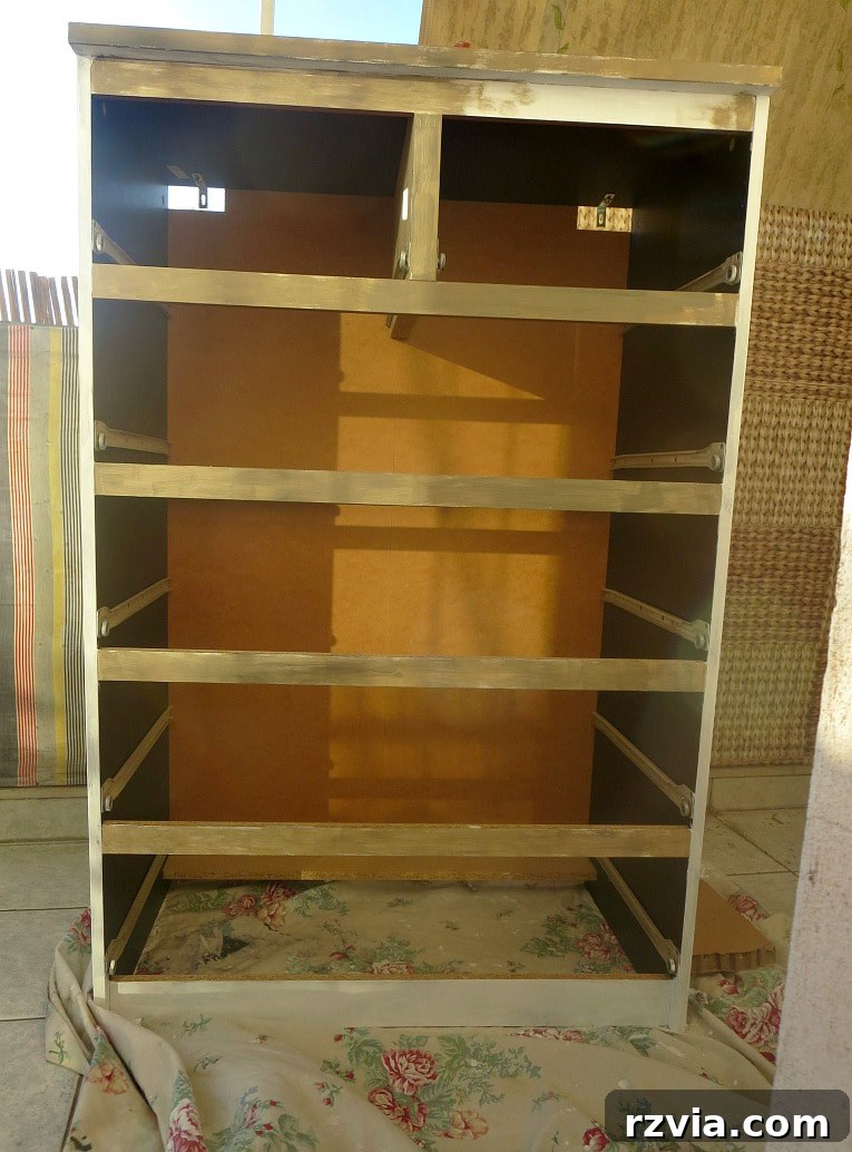 Stunning Black Ikea Malm Dresser Makeovers 10 Painting the front frame of the dresser in the custom brown color, contrasting with the white sides.