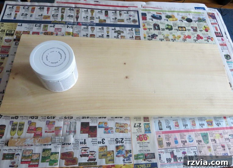 Starting a DIY wooden wall hanger project, showing a plain piece of wood ready for painting with chalky type paint. Perfect for home organization and farmhouse decor.