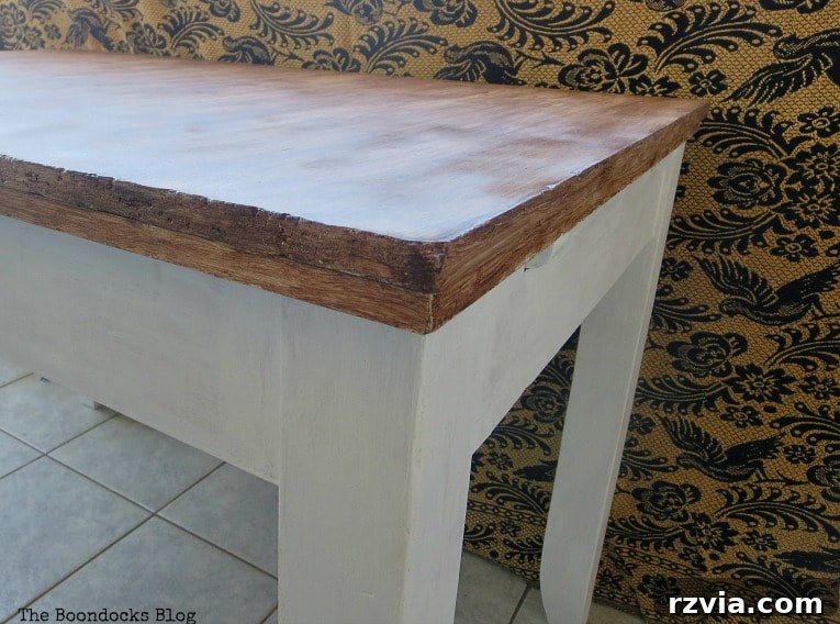 Applying spray varnish to the entire transformed laminate table.