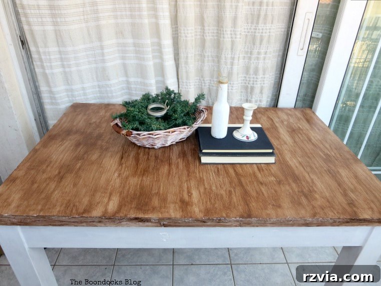 Another 'before' image of the laminate table, emphasizing its tired appearance.
