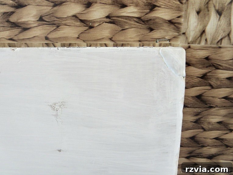 Close-up of the table's repaired edge after being painted over.
