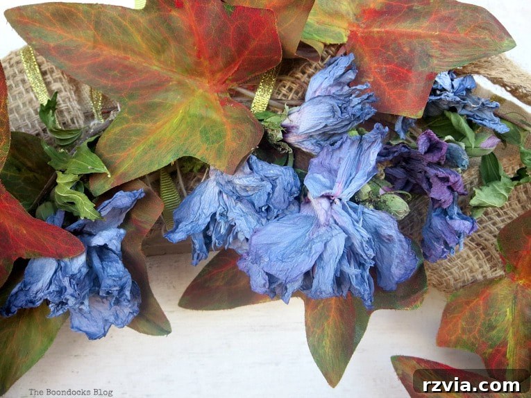 Dollar Store Vine Transformed into a Gorgeous Fall Wreath 11 Adding dried flowers to the DIY fall wreath, enhancing its natural beauty and texture.