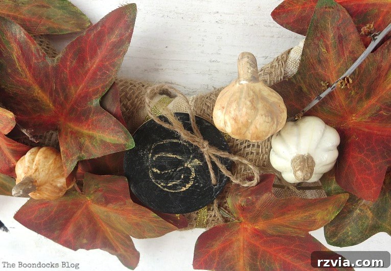 Dollar Store Vine Transformed into a Gorgeous Fall Wreath 18 Adding random stems to the DIY fall wreath to enhance variety and fullness.