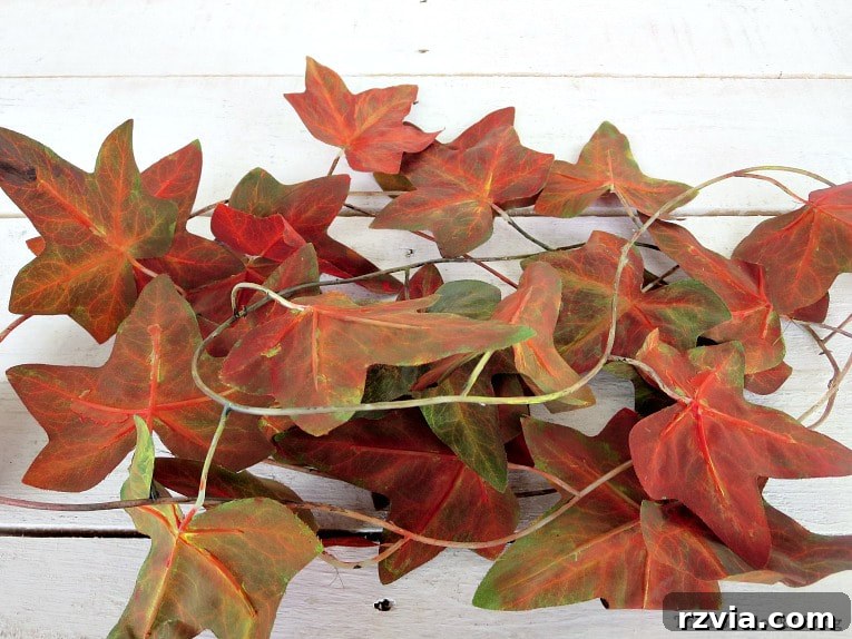 Dollar Store Vine Transformed into a Gorgeous Fall Wreath 5 Close-up of the painted plastic leaves and stems, showcasing the beautiful fall colors achieved for the DIY wreath.