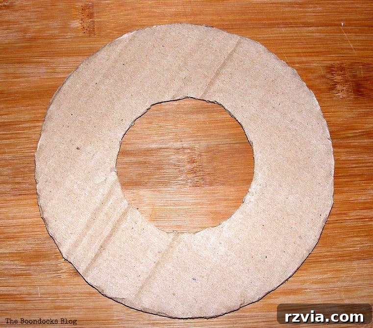 Dollar Store Vine Transformed into a Gorgeous Fall Wreath 6 A piece of cardboard cut into a donut shape, serving as the base for the DIY fall wreath.