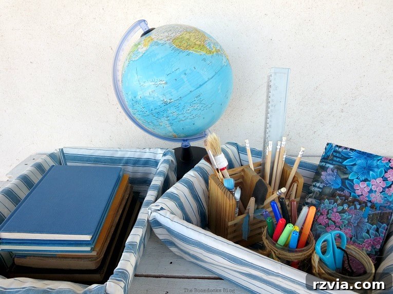 Fabric Fix: Giving New Life to Old Plastic Baskets 12 Both fabric-wrapped baskets, filled with various school supplies and books, elegantly placed next to a vintage globe.