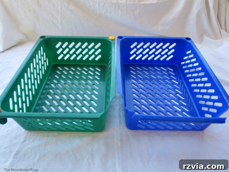 Fabric Fix: Giving New Life to Old Plastic Baskets 3 Close-up view of two older plastic baskets, one green and one blue, clearly showing visible damage and missing edges.