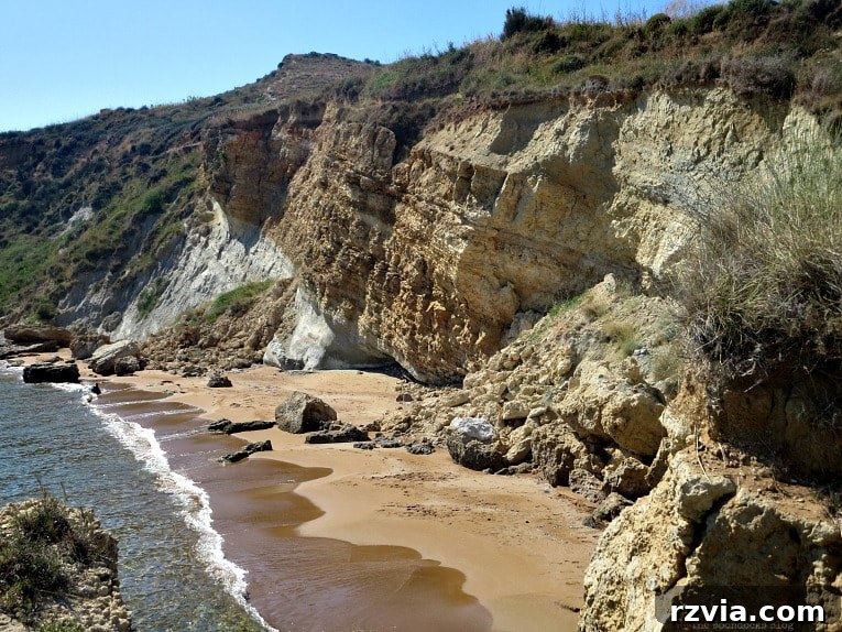 Kefalonia's Rugged Beauty: Where Brown Rocks Meet the Sea 2 Tranquil sandy beach with gentle waves, Kefalonia in brown tones, Greece