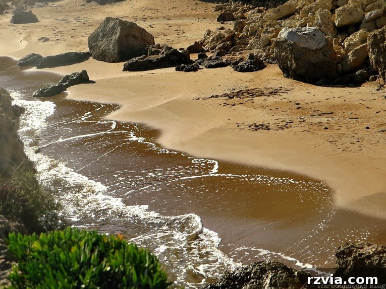Kefalonia's Rugged Beauty: Where Brown Rocks Meet the Sea 13 Gentle waves washing up on the tranquil shore, Kefalonia's serene beach