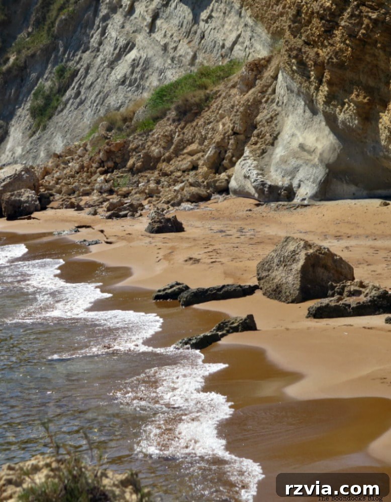 Kefalonia's Rugged Beauty: Where Brown Rocks Meet the Sea 16 Where the serene sea meets brown sand and rugged rocks on Kefalonia's picturesque coastline, Greece