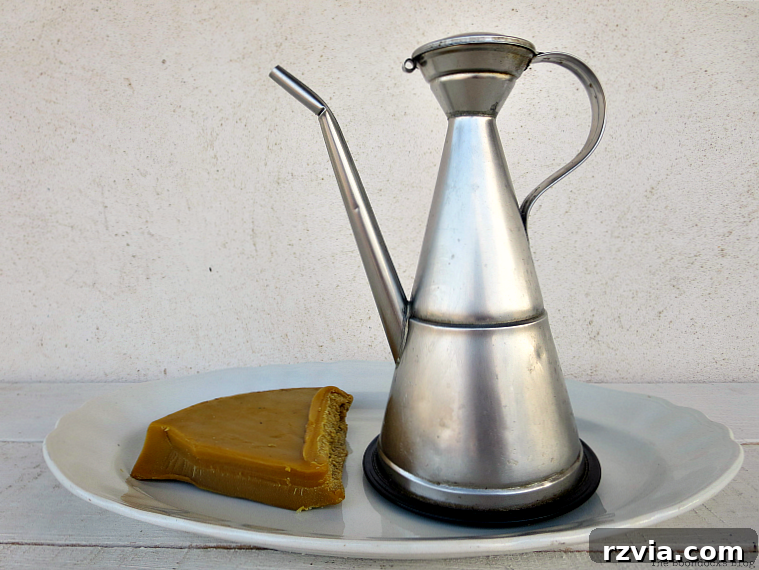 Craft Your Own Natural Beeswax Furniture Polish 3 Piece of beeswax and tin of olive oil placed on a plate.