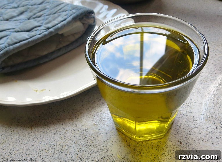 Craft Your Own Natural Beeswax Furniture Polish 5 Olive oil in a glass cup.
