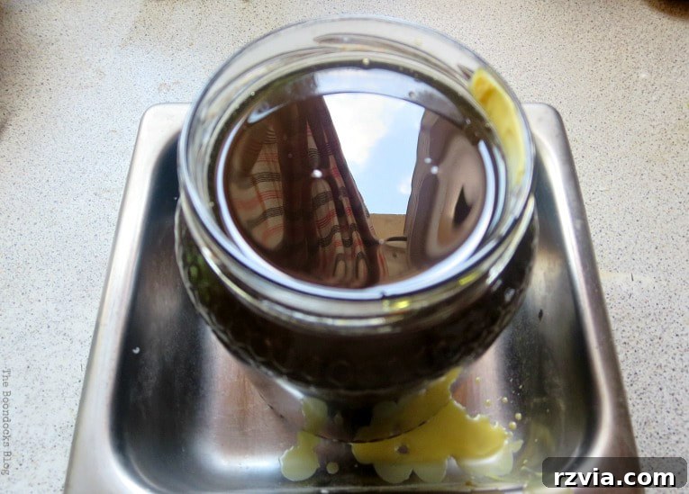 Craft Your Own Natural Beeswax Furniture Polish 9 Beeswax mixture poured into jar.